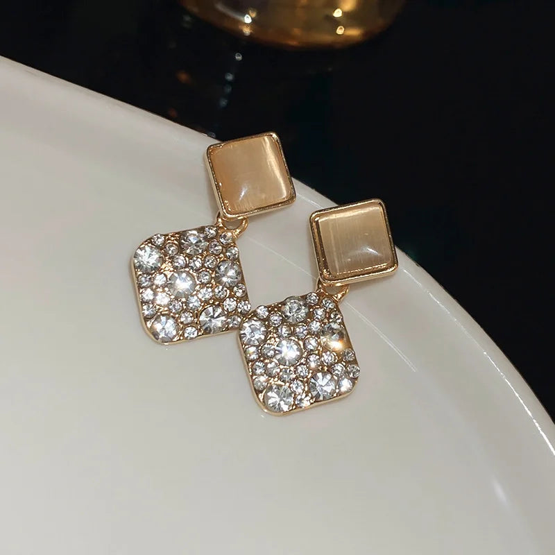 Zircon cross stud earrings worn on ear