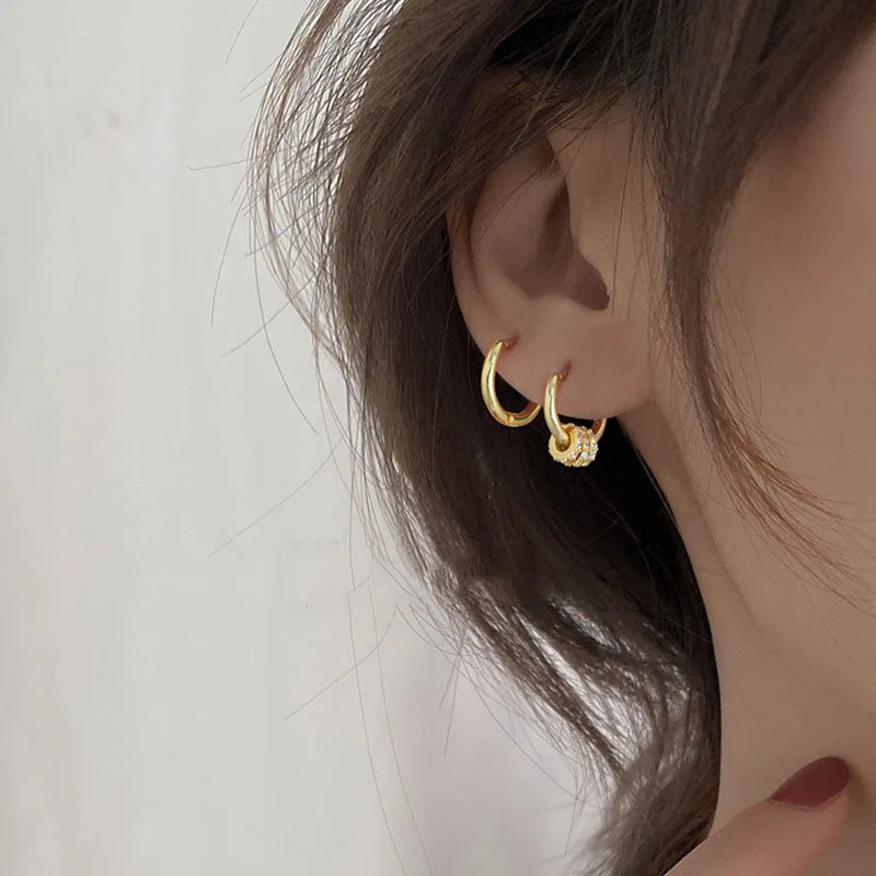 Sleek circle hoop earrings worn on ear