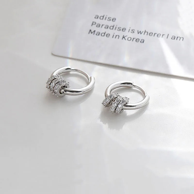 Sleek circle hoop earrings worn on ear