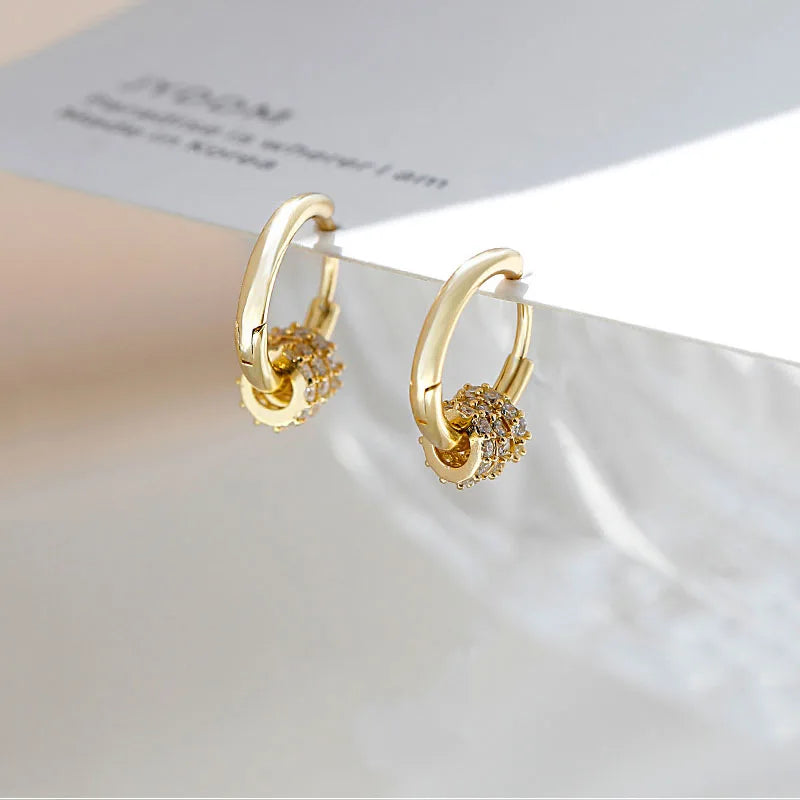 Sleek circle hoop earrings worn on ear