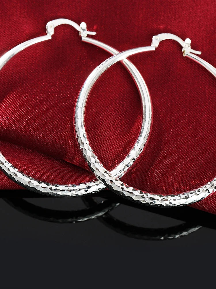 Small circle hoop earrings worn on ear