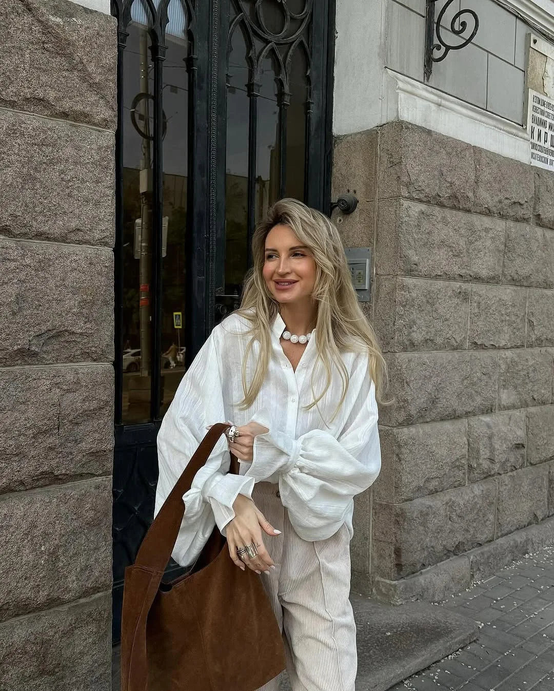 Women's oversized cotton button-up shirt worn as dress