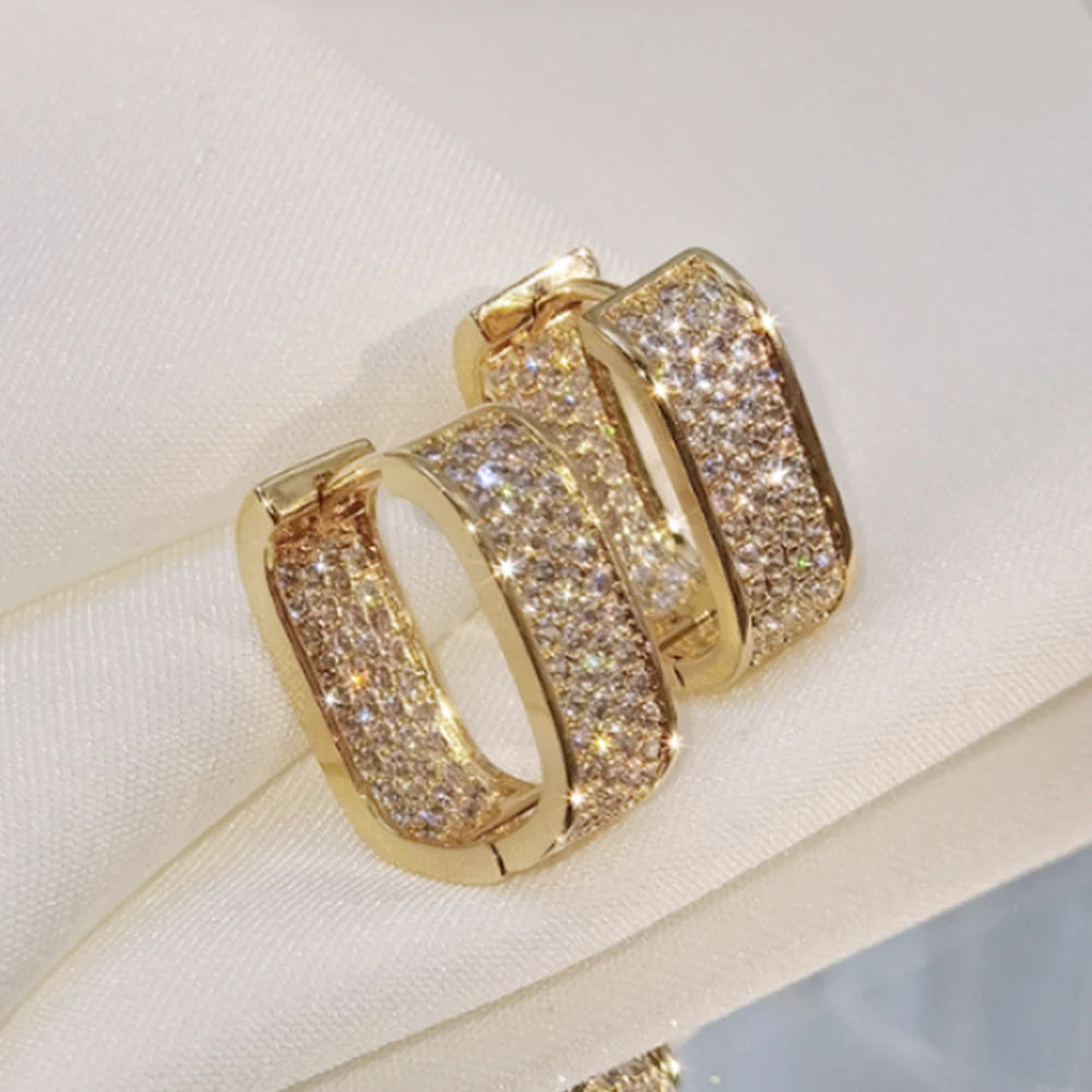 CZ paved hoop earrings worn on ear