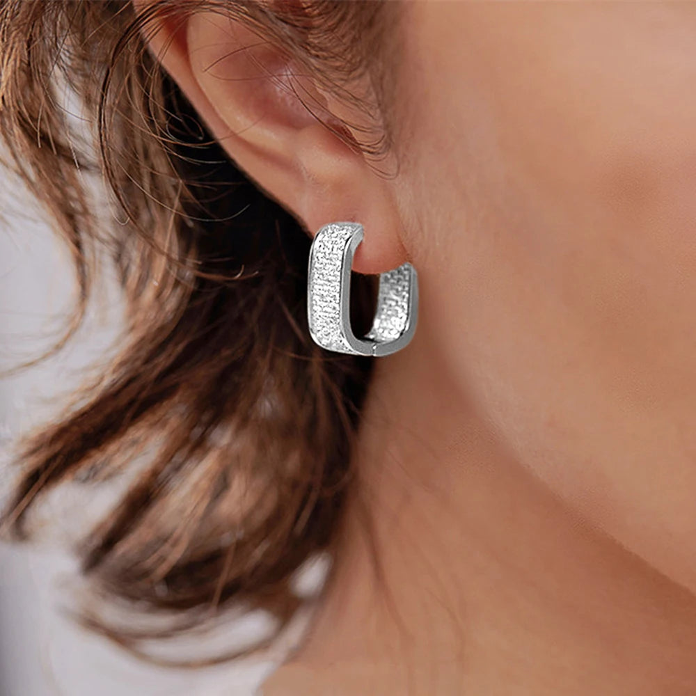 CZ paved hoop earrings worn on ear