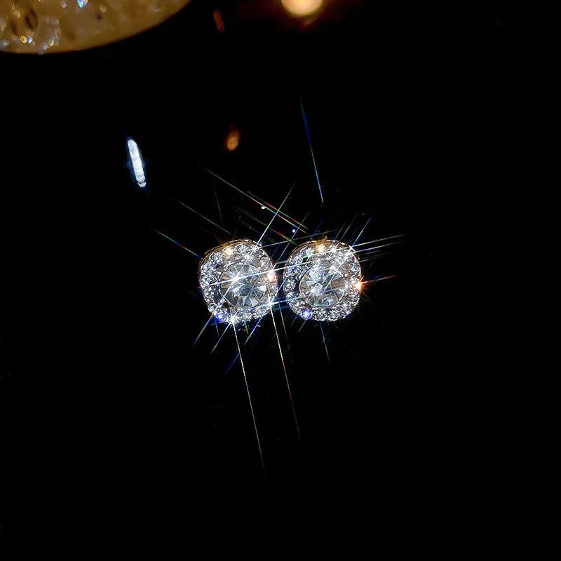 Zircon cross stud earrings worn on ear