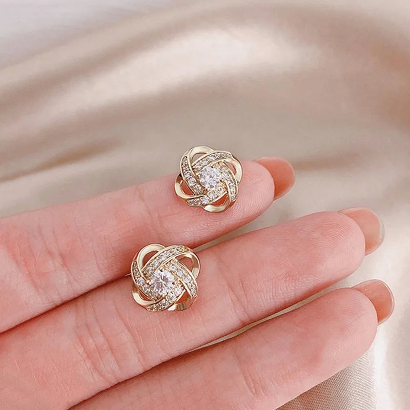 Zircon cross stud earrings worn on ear
