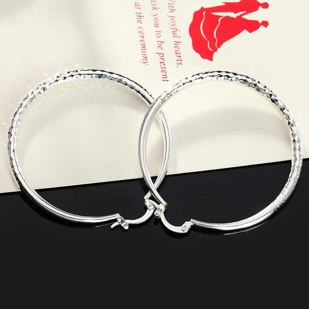 Small circle hoop earrings worn on ear