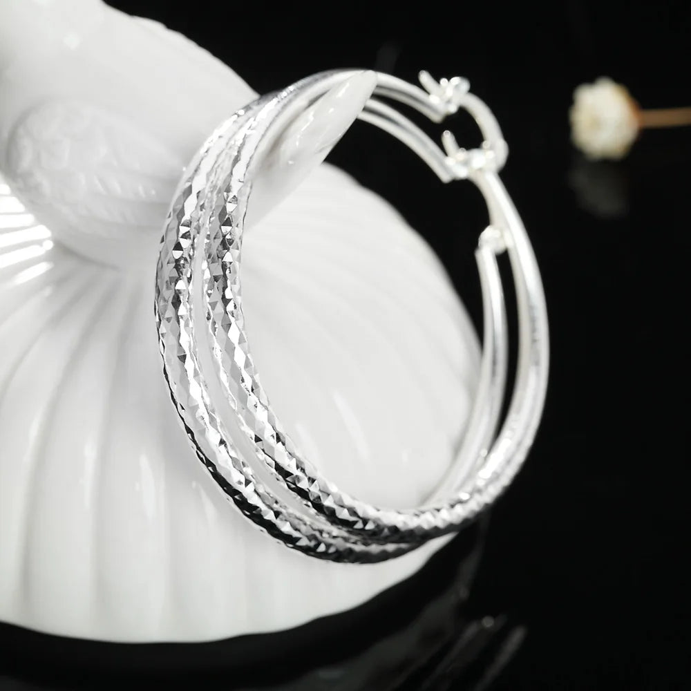 Small circle hoop earrings worn on ear