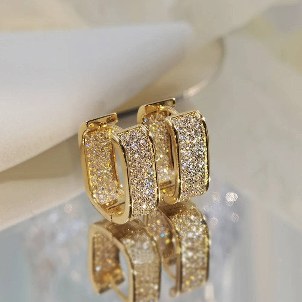 CZ paved hoop earrings worn on ear
