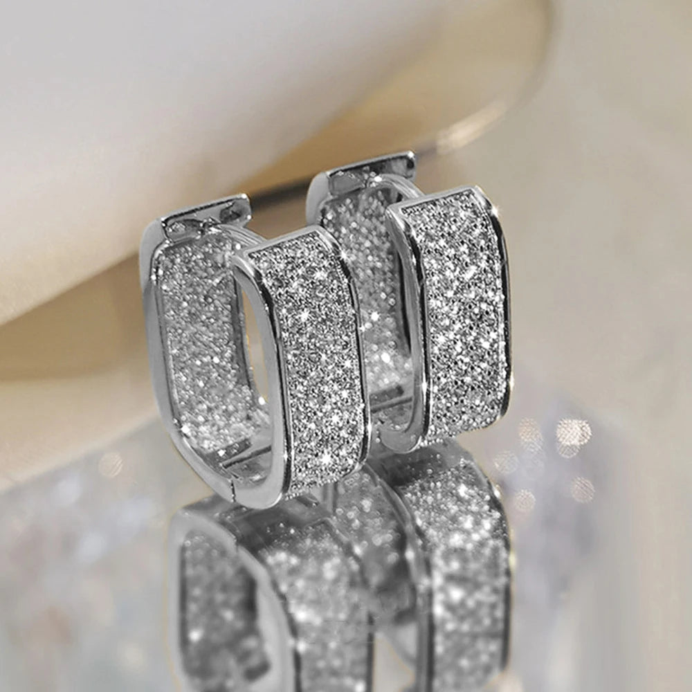 CZ paved hoop earrings worn on ear