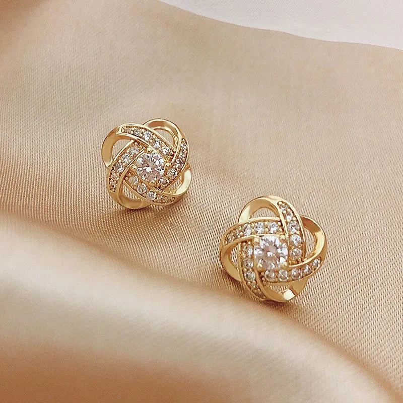 Zircon cross stud earrings worn on ear