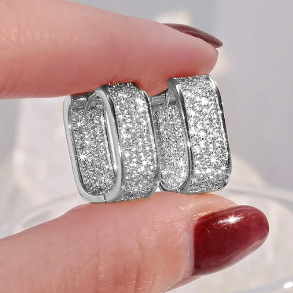 CZ paved hoop earrings worn on ear