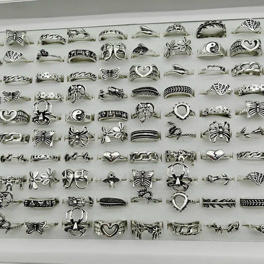 Assorted statement rings worn stacked on fingers