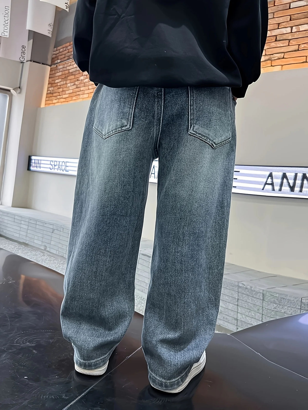 Boys loose fit jeans worn by child