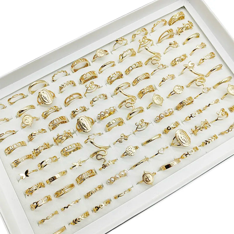 Assorted statement rings worn stacked on fingers