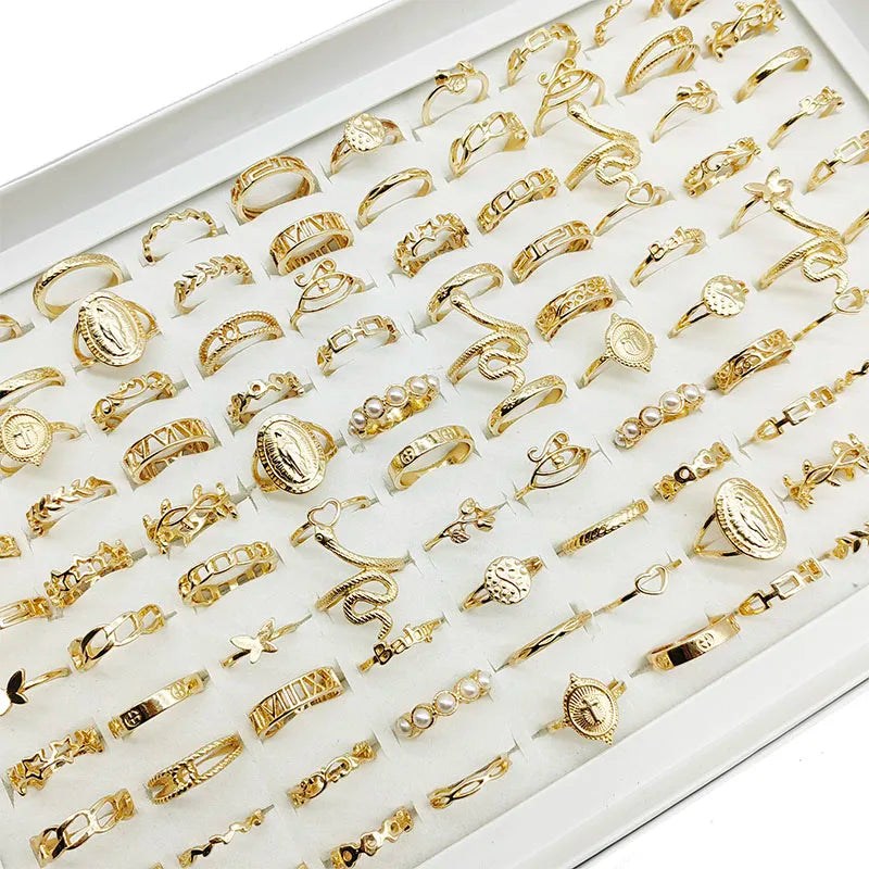 Assorted statement rings worn stacked on fingers