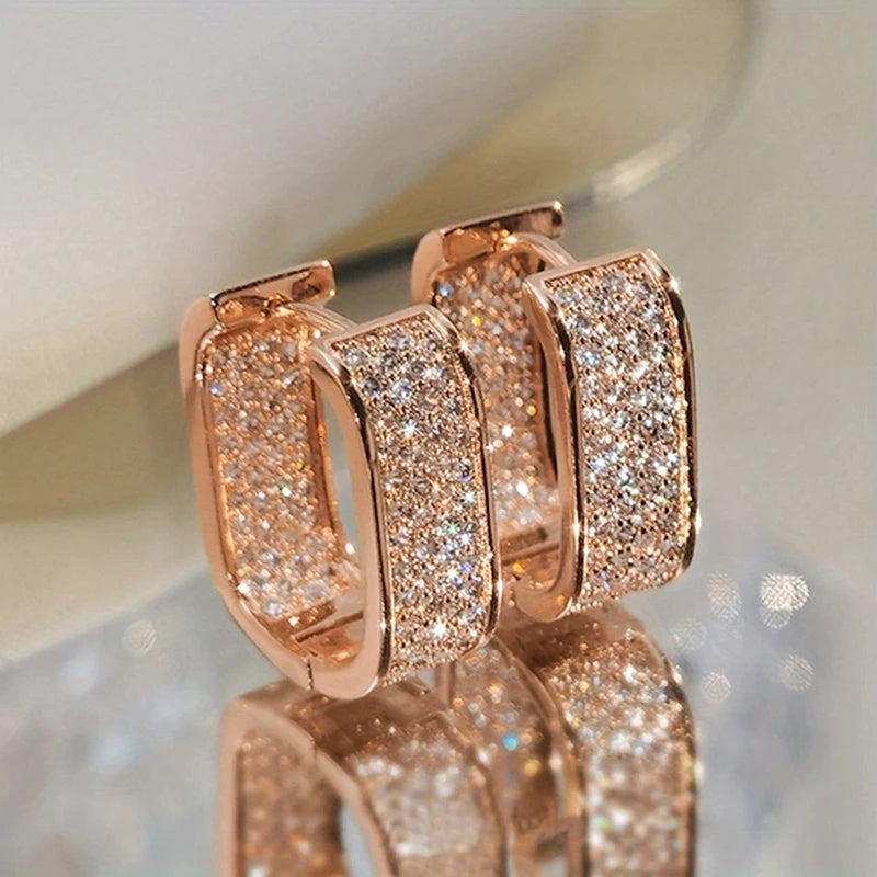 CZ paved hoop earrings worn on ear