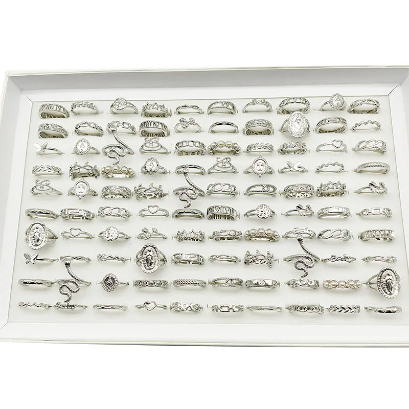Assorted statement rings worn stacked on fingers