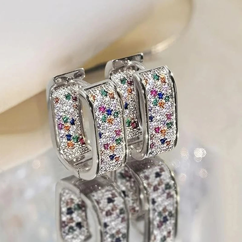 CZ paved hoop earrings worn on ear