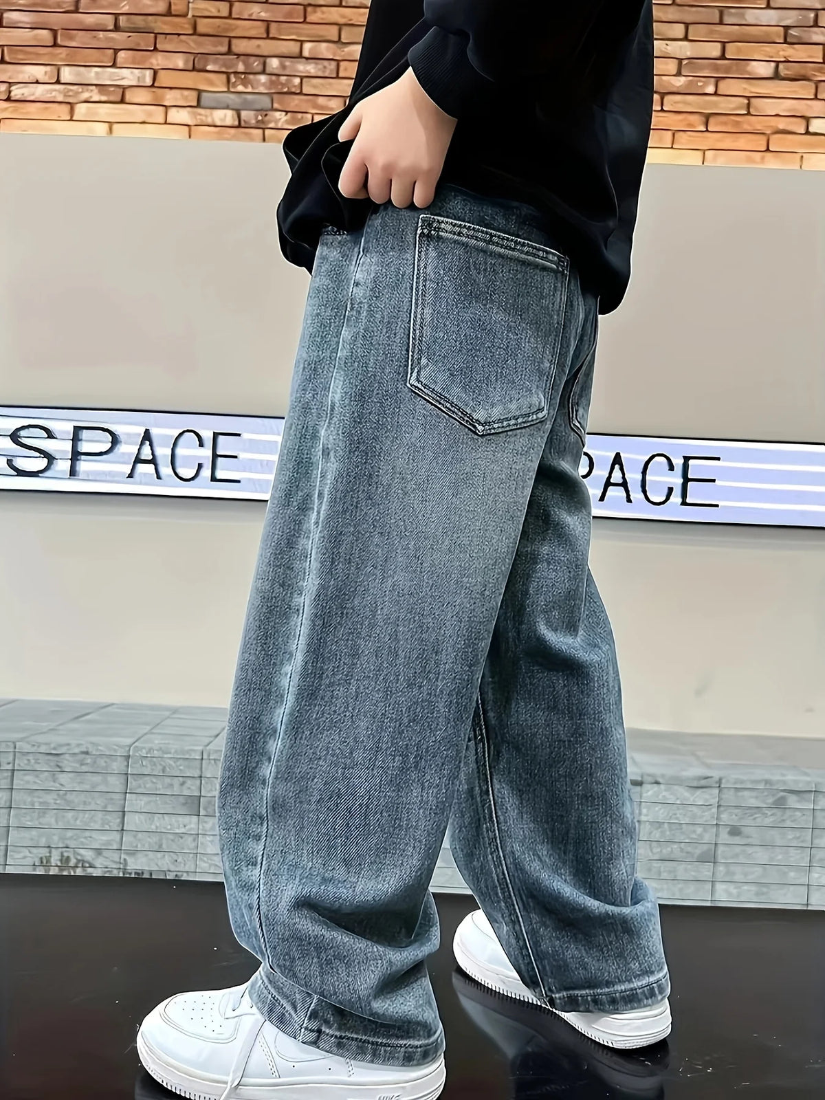 Boys loose fit jeans worn by child