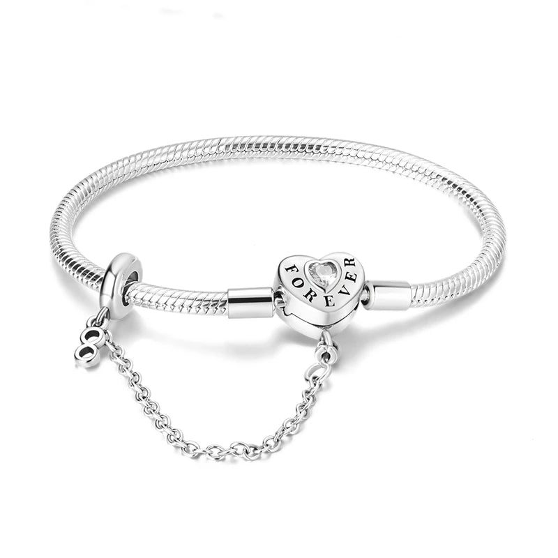 Peach heart charm bracelet worn on wrist