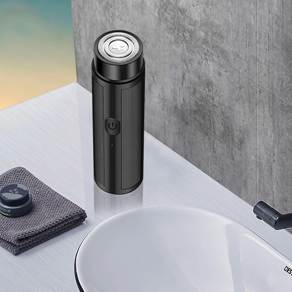 Mini Rechargeable Electric Shaver shown charging via USB port, highlighting travel-friendly design.