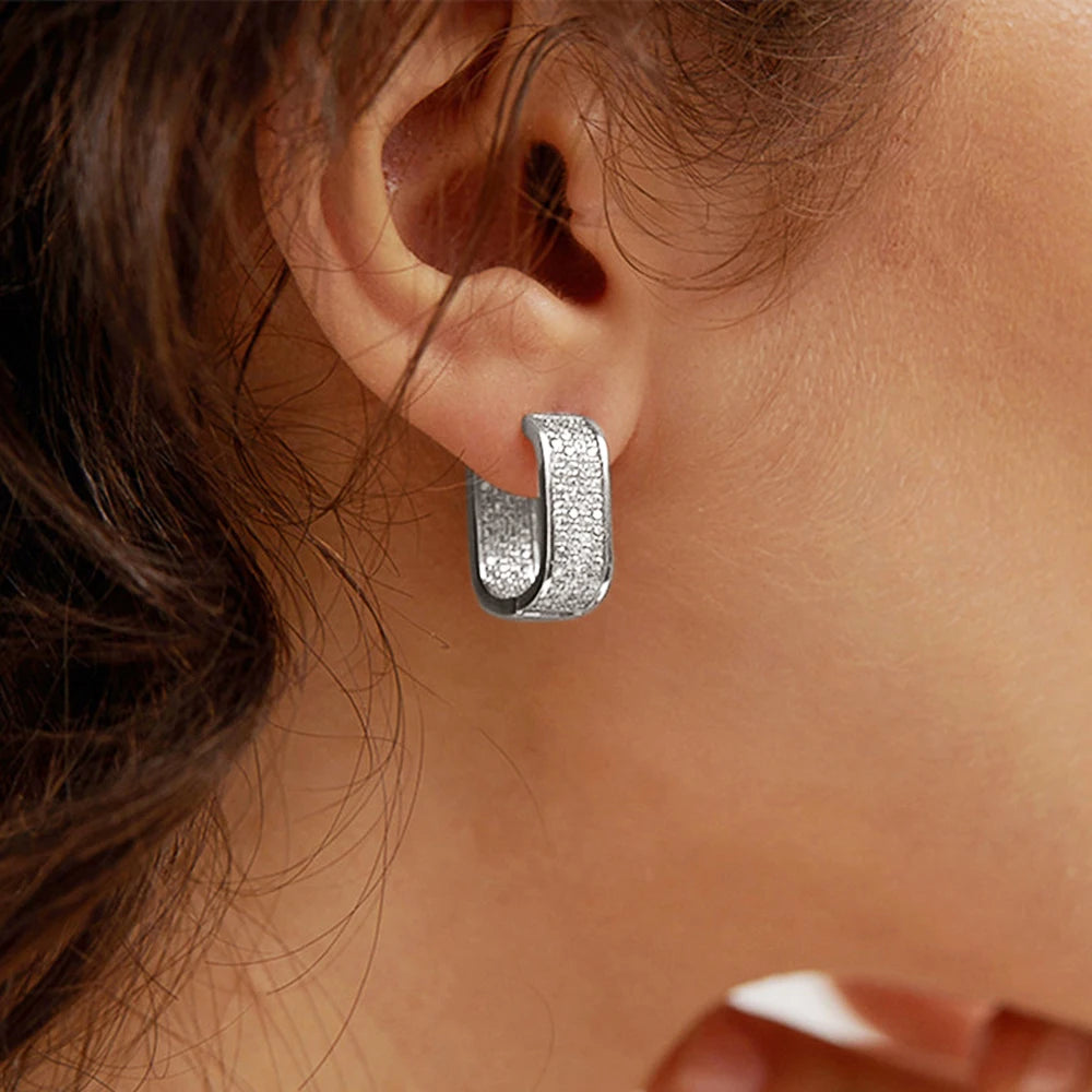 CZ paved hoop earrings worn on ear