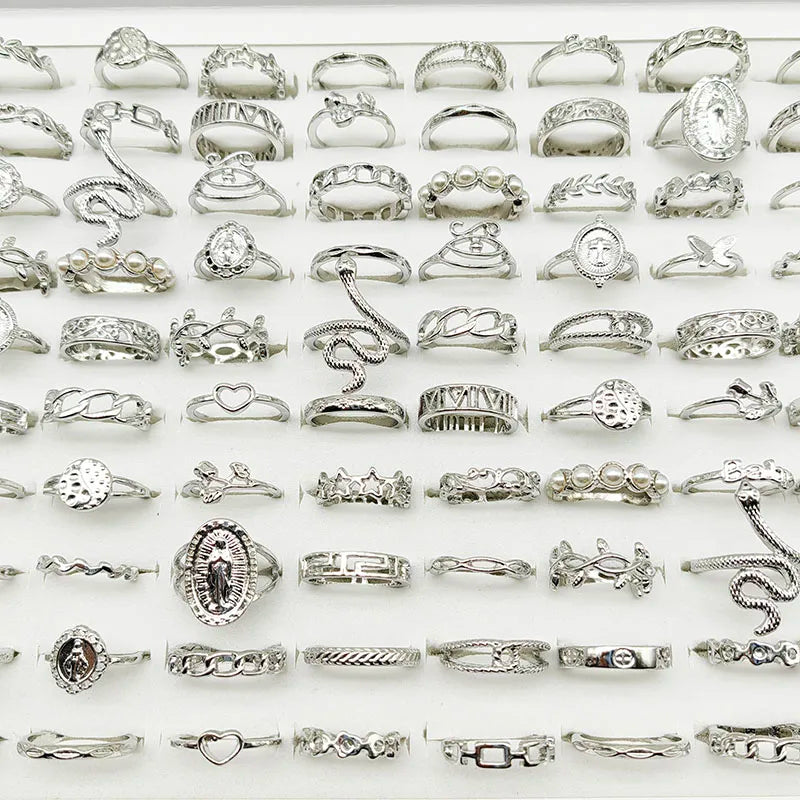 Assorted statement rings worn stacked on fingers