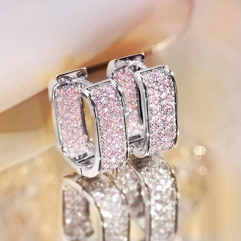 CZ paved hoop earrings worn on ear