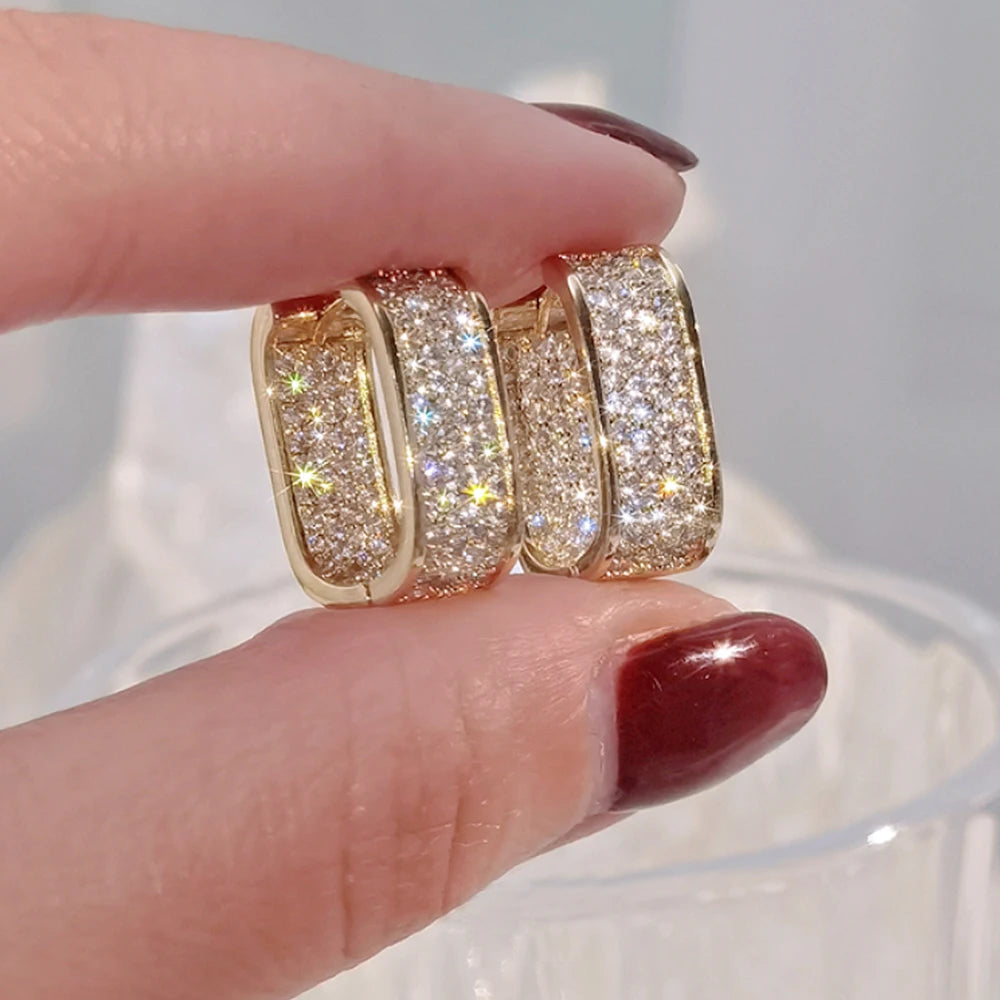 CZ paved hoop earrings worn on ear