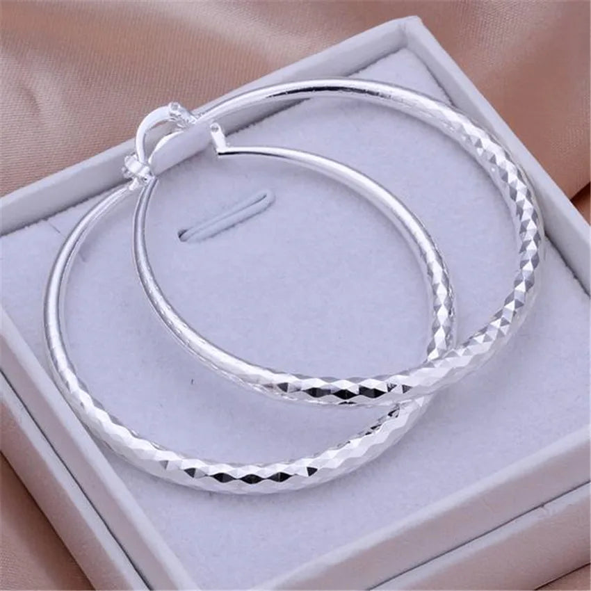 Small circle hoop earrings worn on ear