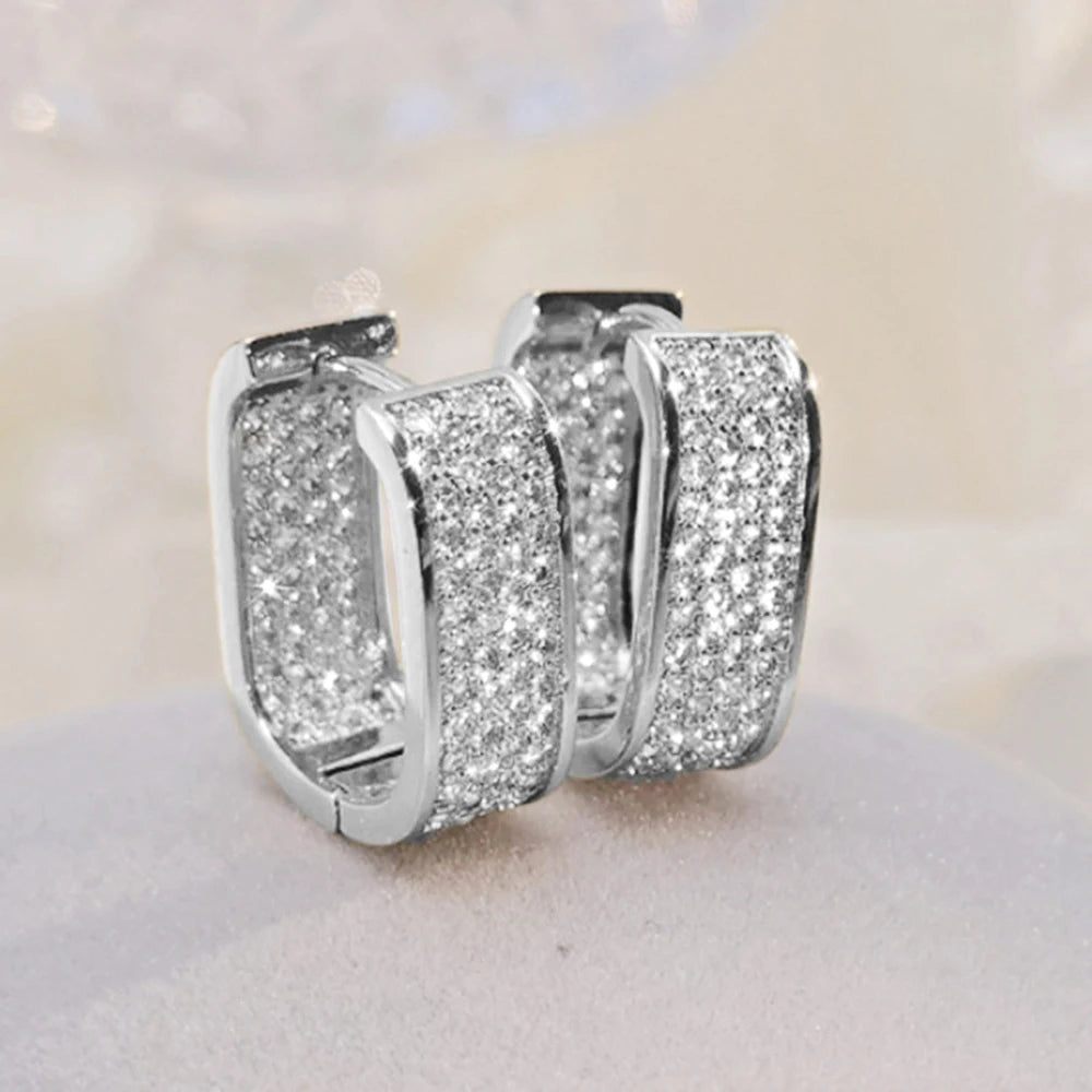 CZ paved hoop earrings worn on ear