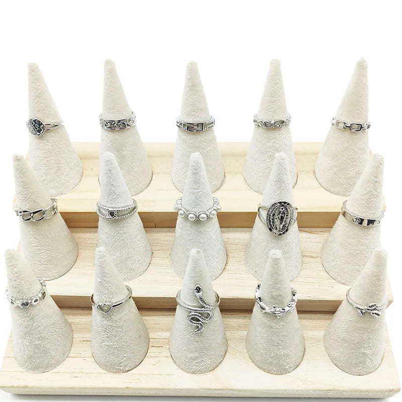 Assorted statement rings worn stacked on fingers