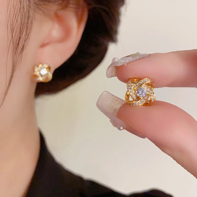 Zircon cross stud earrings worn on ear