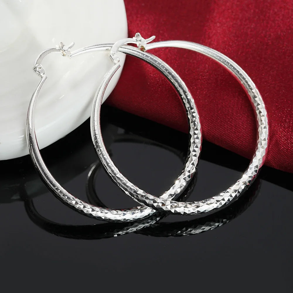 Small circle hoop earrings worn on ear