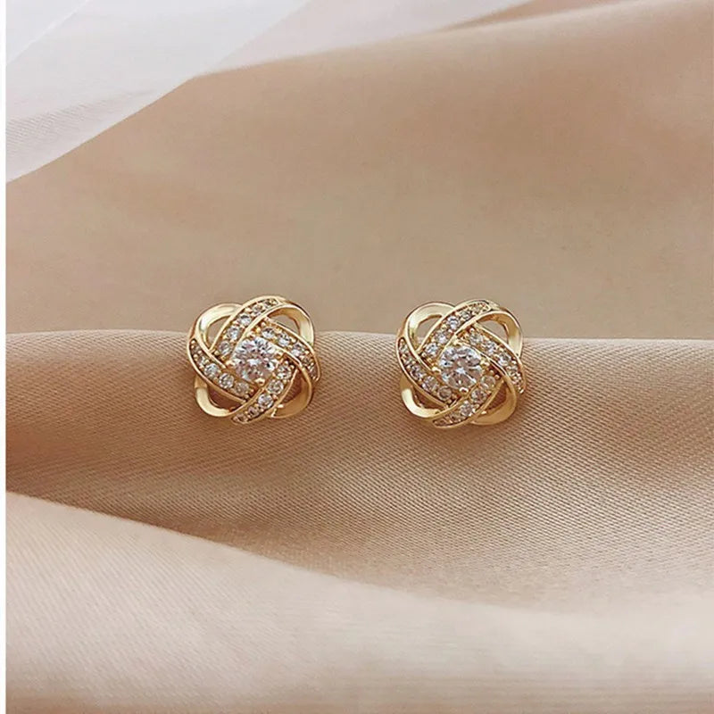 Zircon cross stud earrings worn on ear