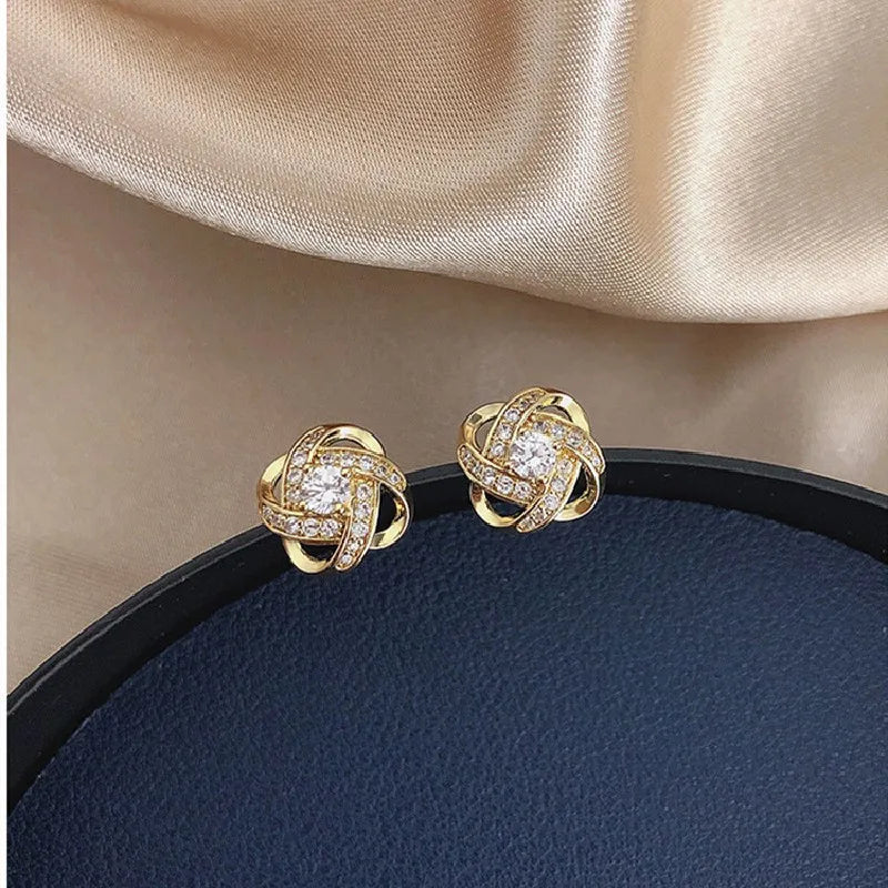 Zircon cross stud earrings worn on ear