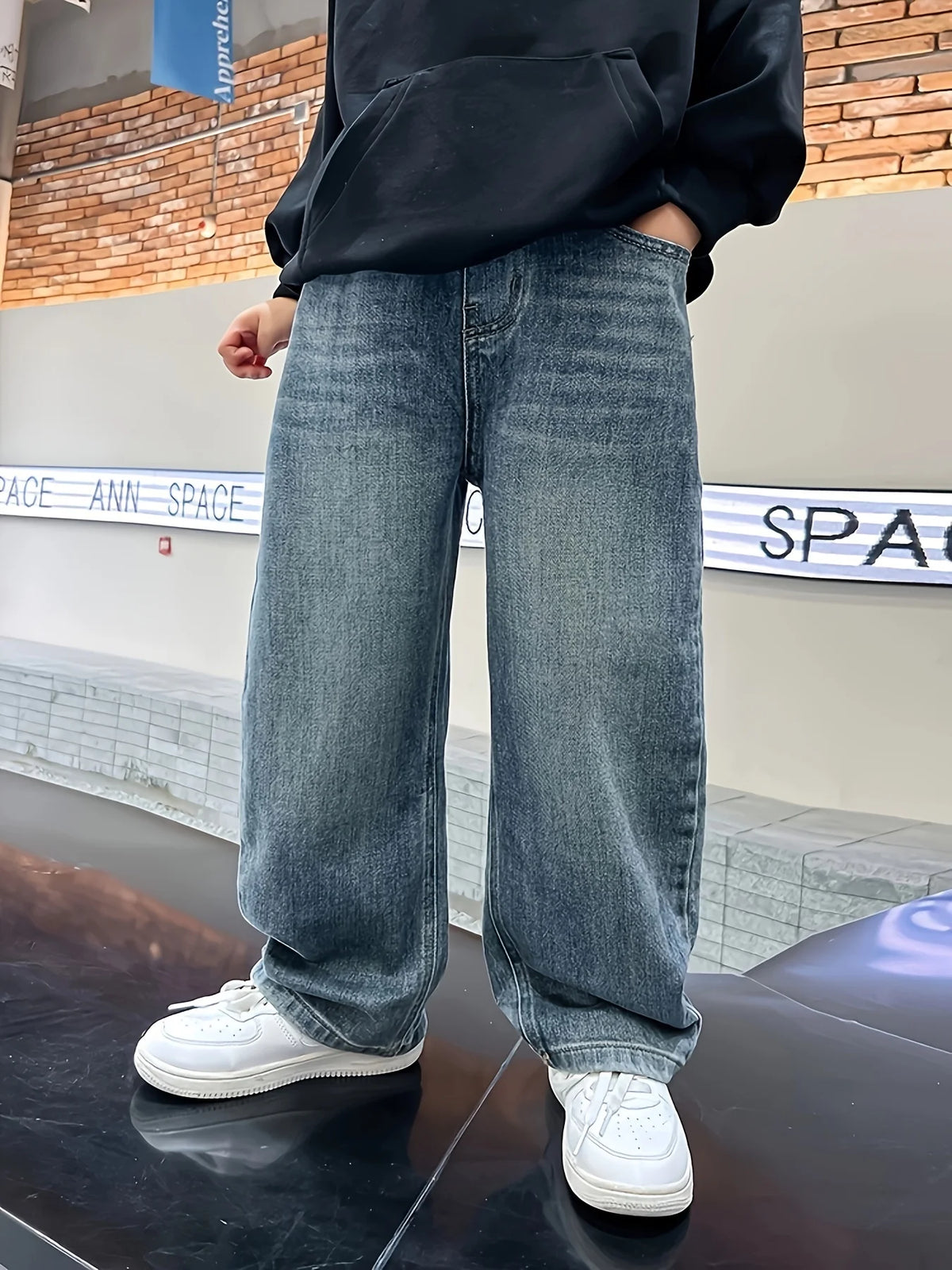 Boys loose fit jeans worn by child