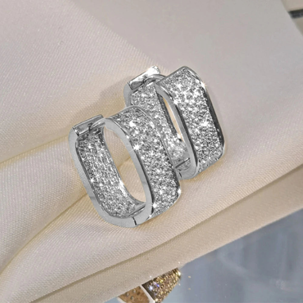 CZ paved hoop earrings worn on ear