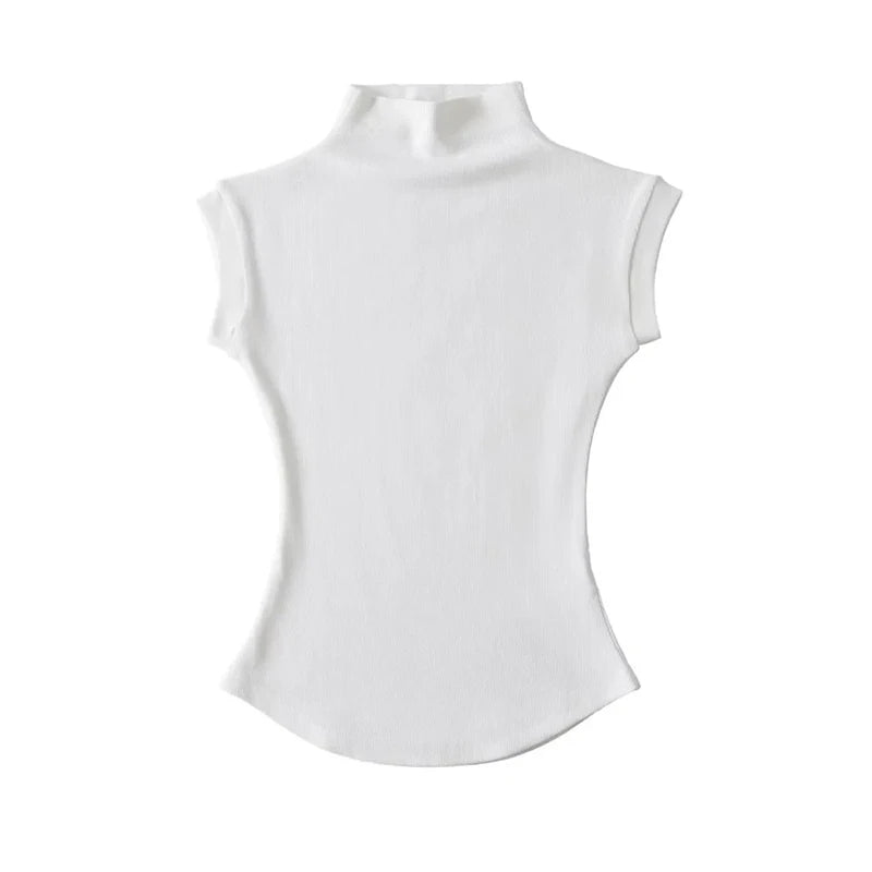 Sleeveless turtleneck top layered under jacket
