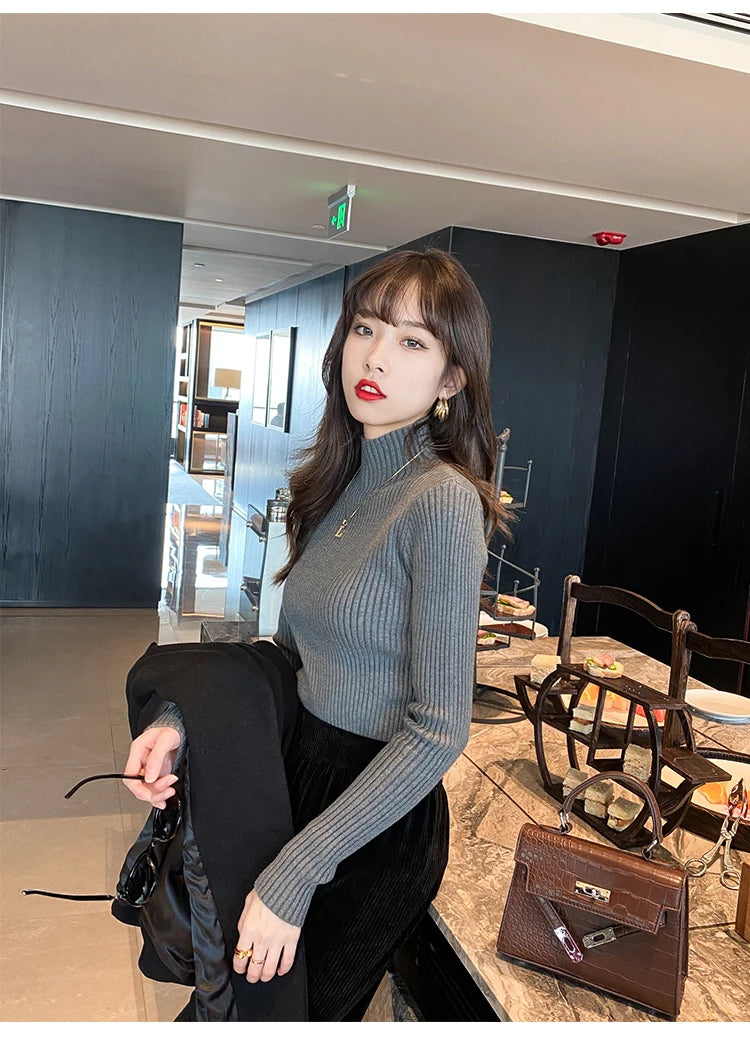 Slim turtleneck sweater khaki styled indoor pose