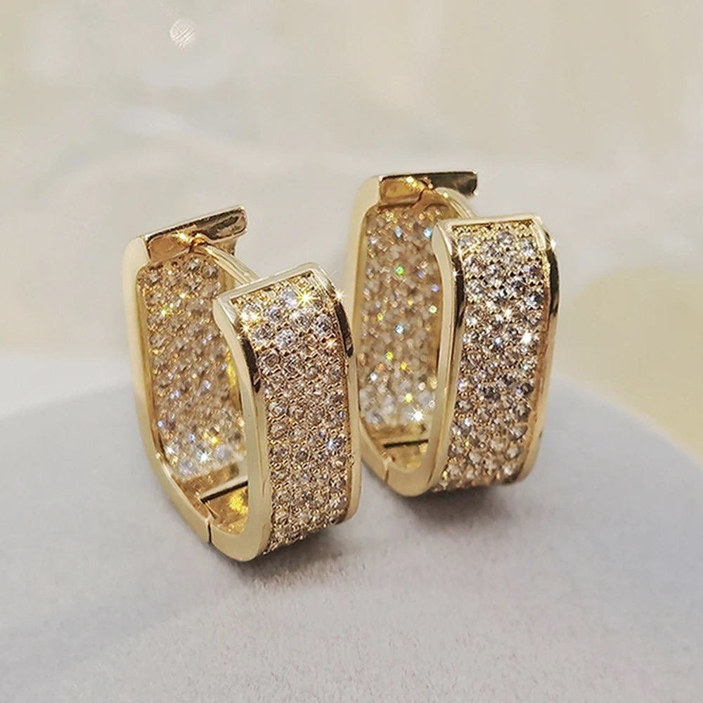 CZ paved hoop earrings worn on ear
