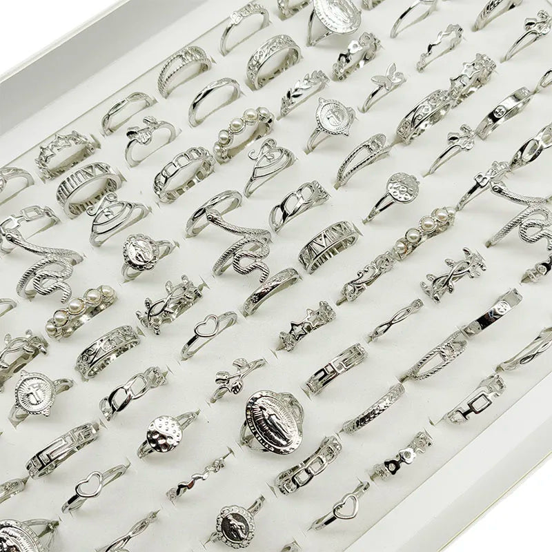 Assorted statement rings worn stacked on fingers