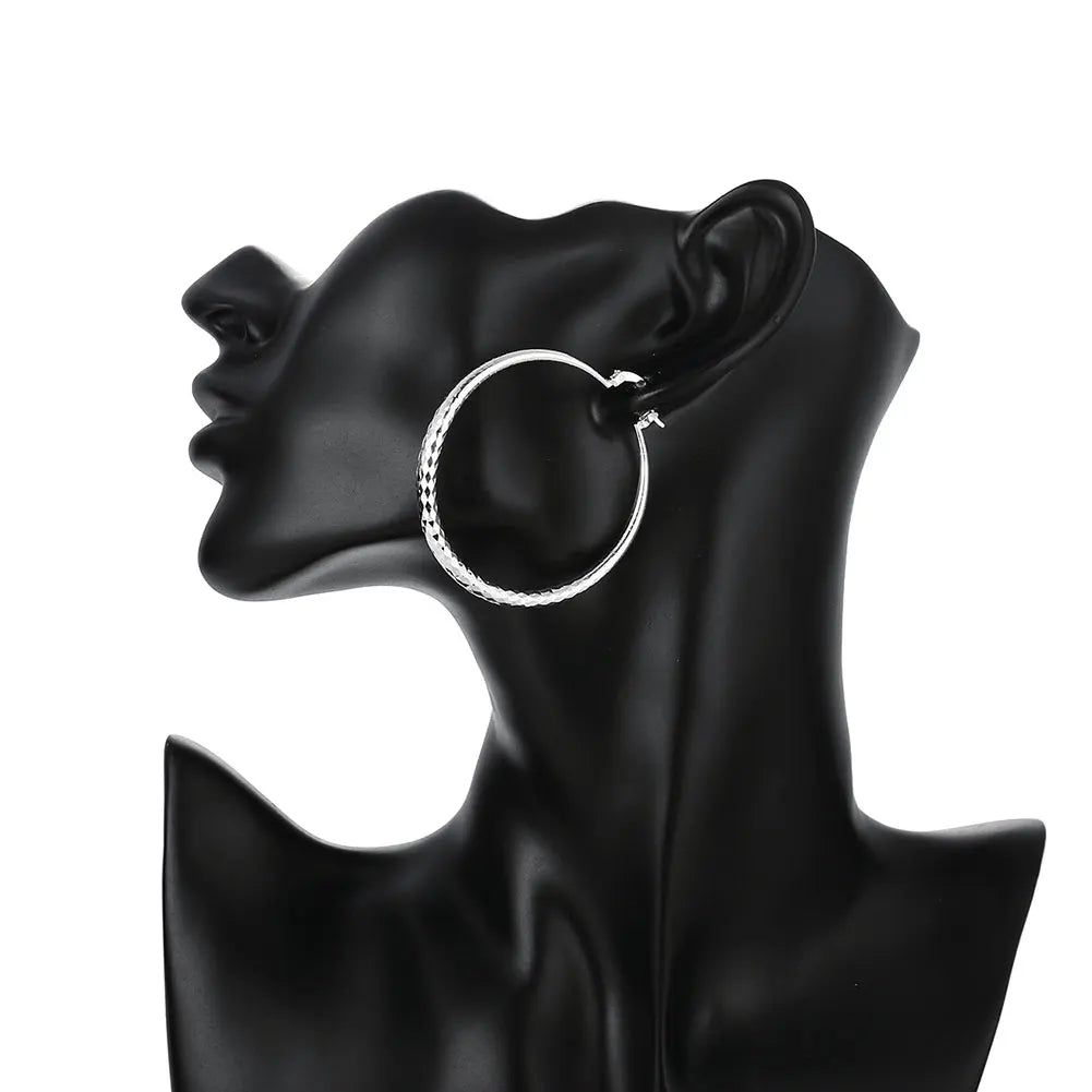Small circle hoop earrings worn on ear